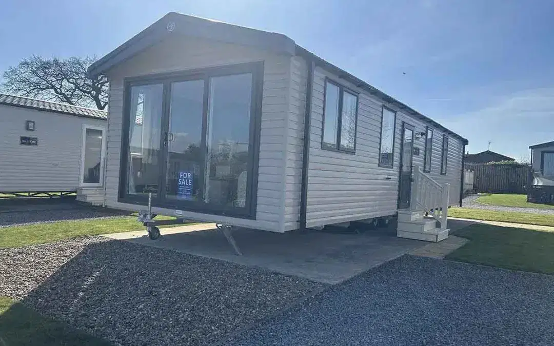 Swift Morlaix static caravan exterior with light paneling and modern design in a holiday park